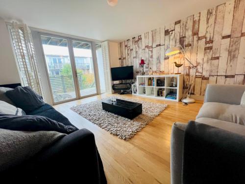 a living room with a couch and a tv at Pass the Keys Royal Sands - A Beachside Haven in Camber