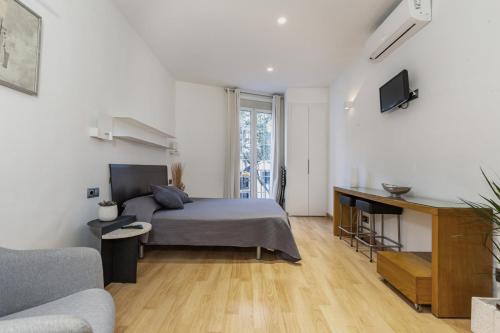 Un pat sau paturi într-o cameră la Alos Apartments Paseo de Gracia-Diagonal