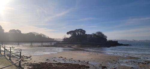 a view of a beach with a pier and the ocean at Villagalicia360 in Bergondo