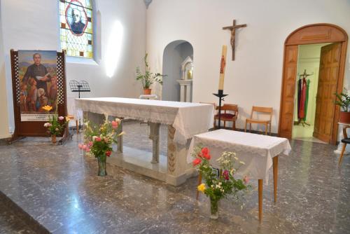 a church with a altar with flowers and a cross at Centre Louis Ormières in Montauban