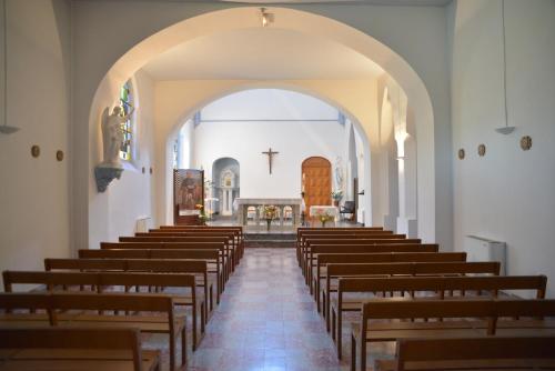 an aisle of a church with wooden pews at Centre Louis Ormières in Montauban