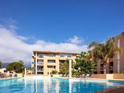 a swimming pool in front of a building at Apartment MB4 Loggia by Interhome in Moriani Plage