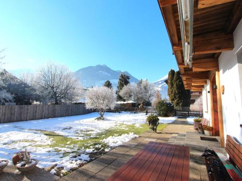 a backyard with snow on the ground and a house at Holiday Home Sonnblick by Interhome in Uderns