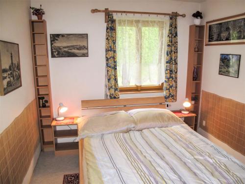 a bedroom with a bed and a window at Villa Petříkov by Interhome in Petříkov