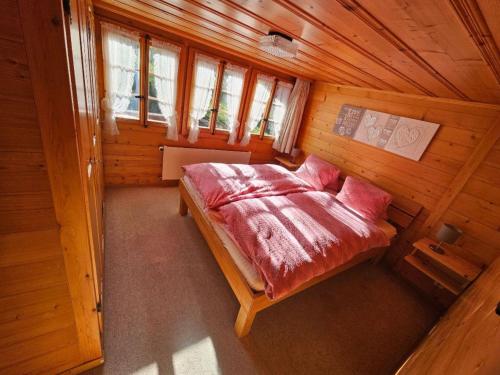 an overhead view of a bedroom in a wooden cabin at Apartment Sommermatte by Interhome in Lauenen
