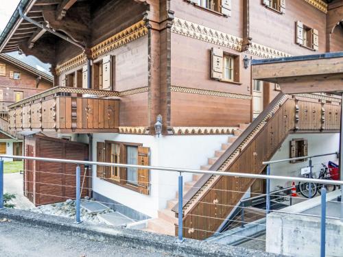 an external view of a building with wooden balconies at Apartment Chalet Pfingstrose by Interhome in Grindelwald
