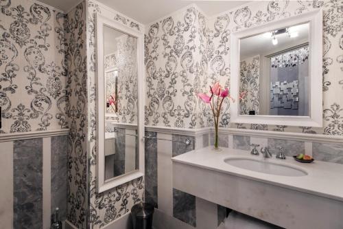 a bathroom with a sink and a mirror at The Inn at the Spanish Steps Luxury Collection - The Inn at the Spanish Steps in Rome
