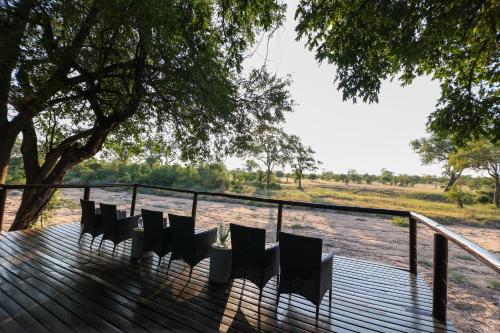 a group of chairs sitting on a wooden deck at Senalala Safari Lodge in Klaserie Private Nature Reserve