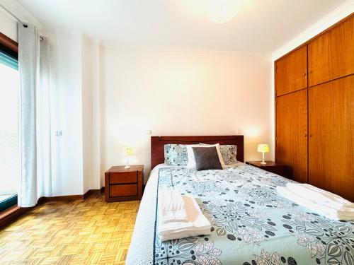 a bedroom with a large bed and a large window at ApuliaMar Apartment in Apúlia