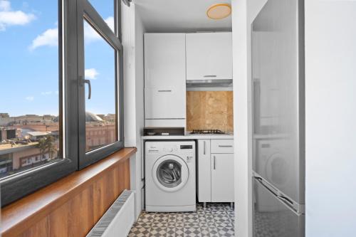 a laundry room with a washer and dryer at Bucharest Mall View in Bucharest