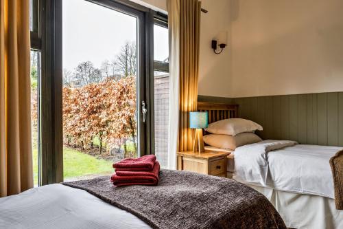 Ένα ή περισσότερα κρεβάτια σε δωμάτιο στο Park Farm Cottages