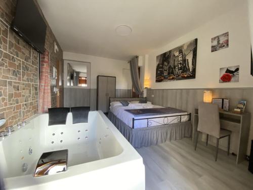 a bathroom with a tub and a bedroom with a bed at Perugia Suite in Perugia
