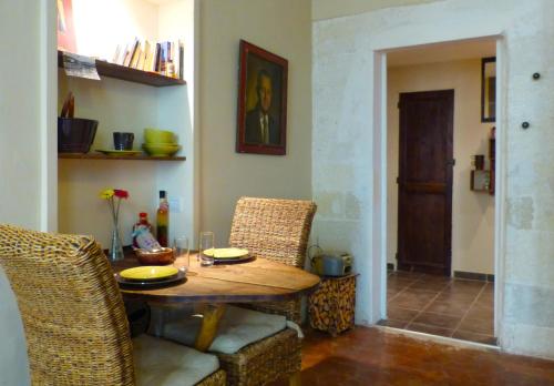 une salle à manger avec une table et des chaises en bois dans l'établissement Les Remparts, à Avignon