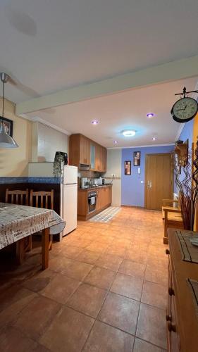 a large kitchen with a table and a counter top at 21A02 Coqueto apartamento con garaje in Felechosa
