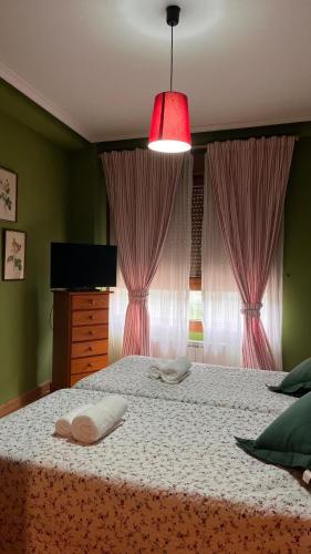 a bedroom with a bed with two pillows on it at 21A02 Coqueto apartamento con garaje in Felechosa