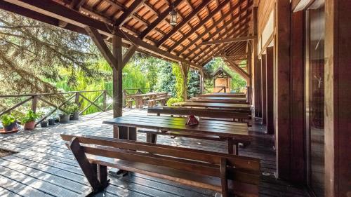 a row of wooden benches sitting on a deck at Róża Wiatrów in Węgorzewo