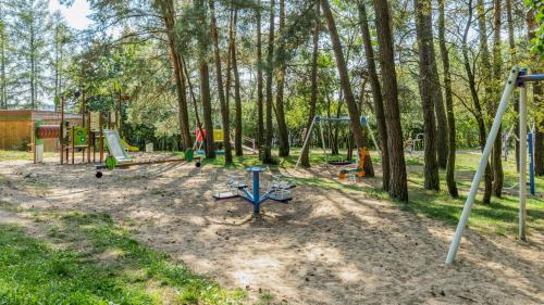 a playground with many swings in a park at Róża Wiatrów in Węgorzewo