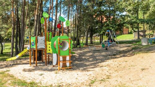 a playground in a park with playground equipment at Róża Wiatrów in Węgorzewo