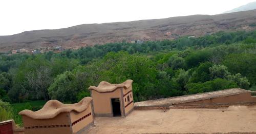 a building with a door on top of a hill at Dar Laayoune in Kalaat MGouna
