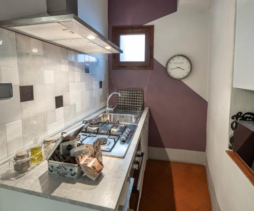 a kitchen with a stove and a clock on the wall at Canto degli Scali in Florence