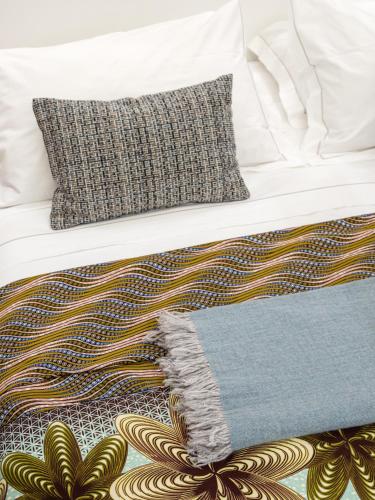 a bed with two pillows and a blanket on it at Canto degli Scali in Florence