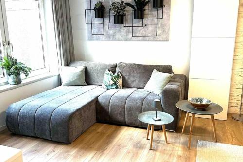 a living room with a couch and a table at Wohlfühlapartment in Wals vor den Toren Salzburg in Wals