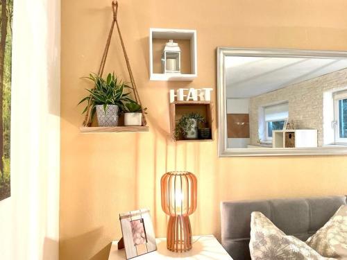 a living room with a couch and a mirror at Wohlfühlapartment in Wals vor den Toren Salzburg in Wals