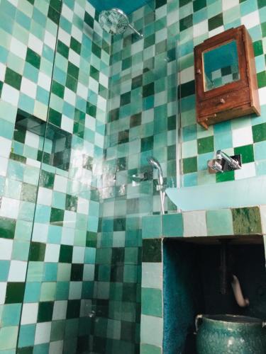 a bathroom with a sink and a tiled wall at Unique Townhouse with rooftop pool in Estepona