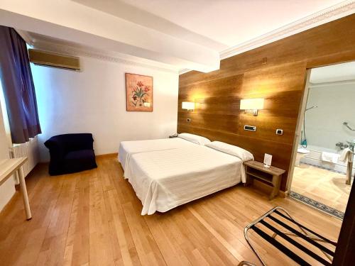 a bedroom with a large white bed in a room at Hotel Virrey in Arnedo
