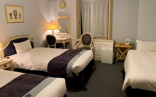 Postel nebo postele na pokoji v ubytování Hotel Monterey Osaka