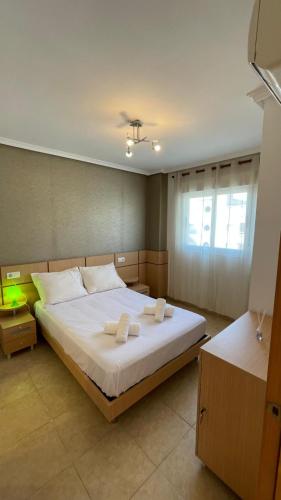a bedroom with a large bed with two towels on it at Apartamento Magic World Neptuno in El Borseral