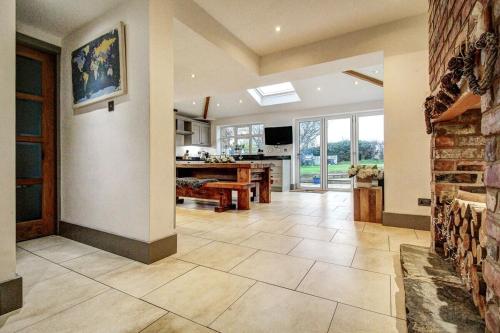 a large living room with a fireplace and a table at The Family Holiday In West Kirby By Cheshire Escapes in Wirral