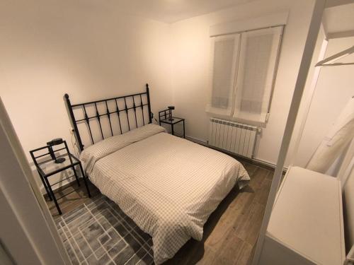 a small bedroom with a bed and a window at Casa Matías in Villarcayo