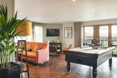 a living room with a pool table and a couch at The Retreat in Penruddock