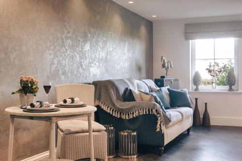 a living room with a couch and a table at The Retreat in Penruddock