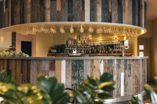 a bar in a restaurant with wine glasses at The Retreat in Penruddock