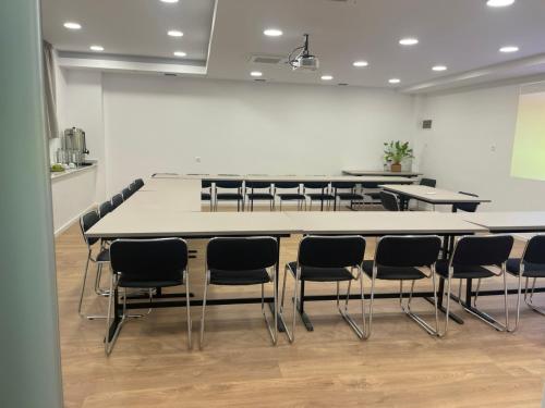 a conference room with a large table and chairs at Electra Hotel in Stavros