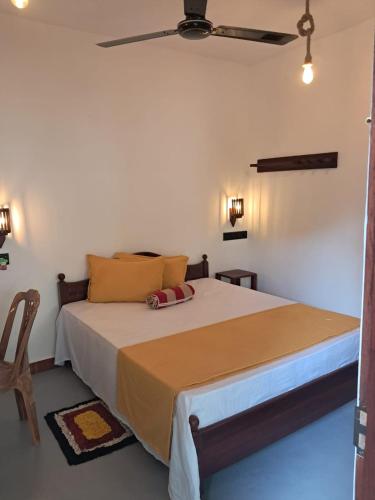 a bedroom with a large bed with a ceiling at Sulo House in Weligama