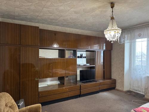 a living room with a large entertainment center with a television at Apartment near Opera Hause in Dnipro