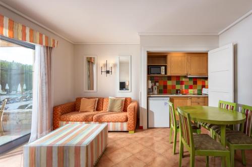 a living room with a couch and a table at Grande Real Santa Eulalia Resort & Hotel Spa in Albufeira