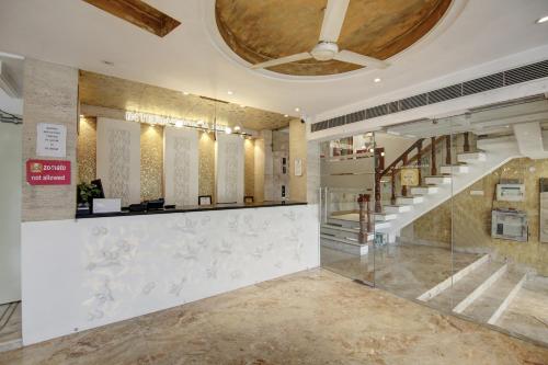 a lobby with a staircase in a building at Hotel International Inn - Near Delhi Airport in New Delhi