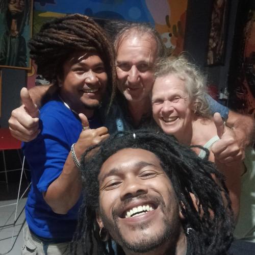 a group of three people posing for a picture at Kristian Homestay in Bajawa