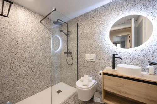 a bathroom with a shower and a toilet and a sink at Apartamento Turístico Royal, by CartagenaSpain in Cartagena