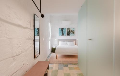 a bedroom with a bed and a mirror at SCALA by Valletta Vintage in Valletta
