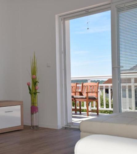 a living room with a sliding glass door to a balcony at Apartments Zelic in Vodice