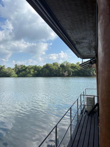 a boat on a lake with trees in the background at บ้านต้นรักษ์ BanTonRuk Takuapa in Takua Pa