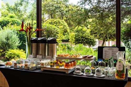a table with a bunch of food on it at NH Collection Bogota Hacienda Royal in Bogotá
