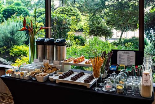 a buffet of desserts and pastries on a table at NH Collection Bogota Hacienda Royal in Bogotá