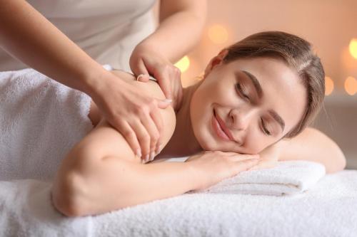 a woman getting a massage from a therapist at Villa HG37 Kopiaste - Newly Refurbished Villa with Private Pool & Private Garden, Aphrodite Hills in Kouklia