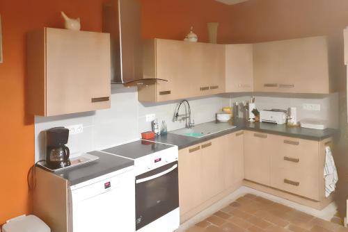 a small kitchen with white cabinets and a sink at Villa spacieuse à Chandolas avec piscine privée in Chandolas